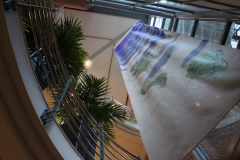 The flag hanging from the fifth floor looking up from the reception